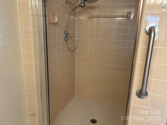 bathroom with a shower with shower door