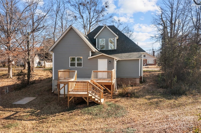 rear view of property featuring a wooden deck