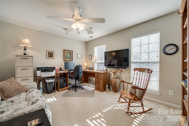 home office with light carpet and ceiling fan