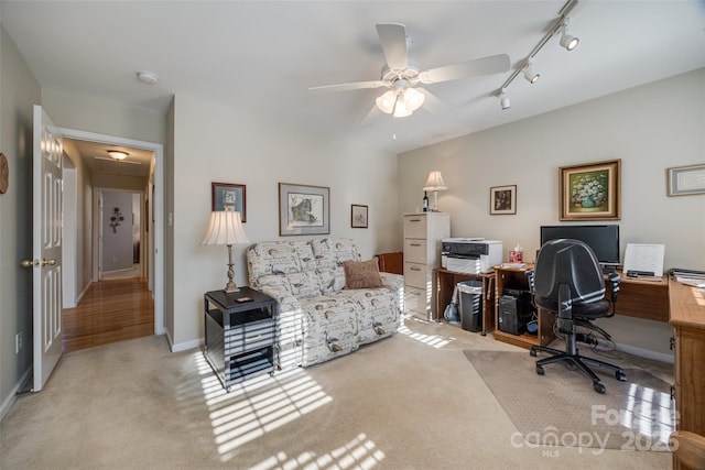 carpeted home office featuring ceiling fan and rail lighting