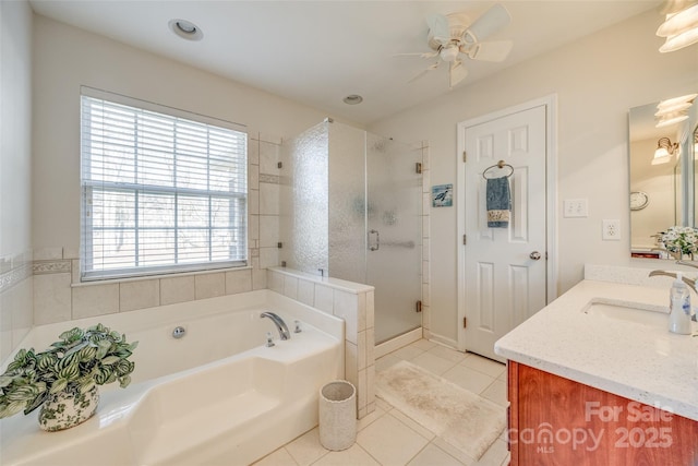 bathroom with plenty of natural light, tile patterned floors, vanity, and shower with separate bathtub