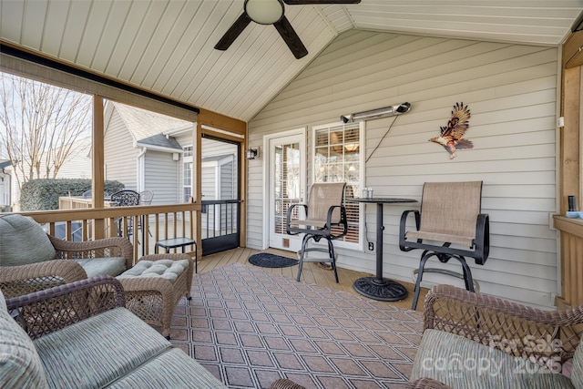 sunroom / solarium featuring ceiling fan and lofted ceiling