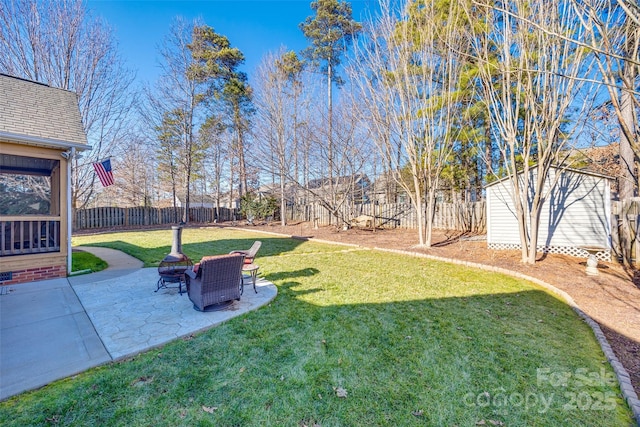 view of yard featuring a patio area, a shed, and an outdoor fire pit