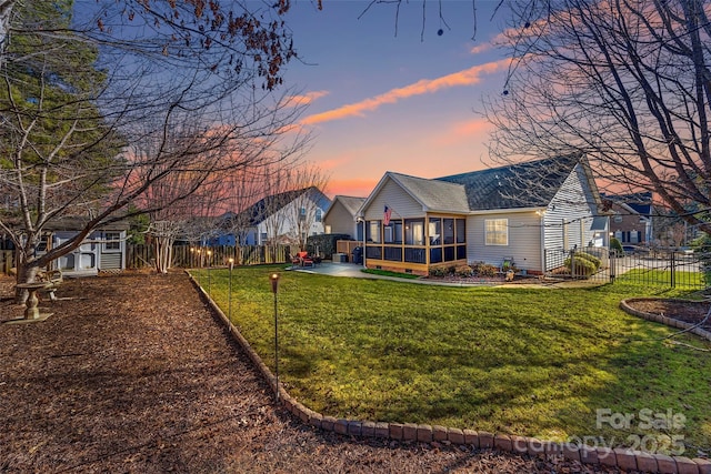 exterior space featuring a lawn and a sunroom