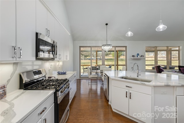 kitchen with sink, white cabinetry, hanging light fixtures, an island with sink, and stainless steel appliances