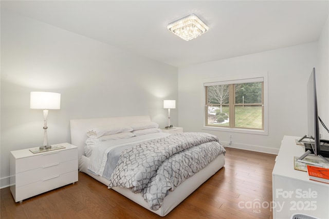 bedroom with wood-type flooring