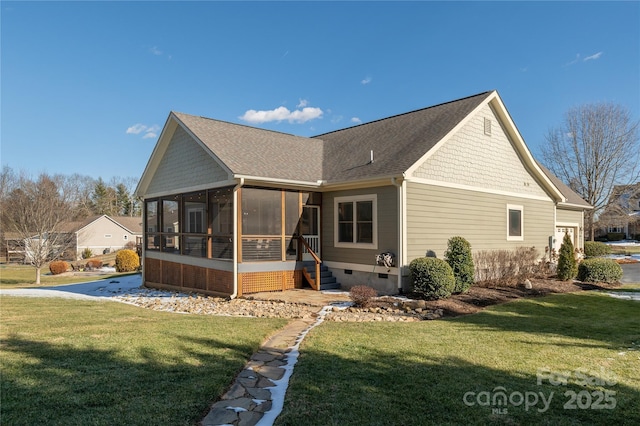 rear view of property with a yard and a sunroom