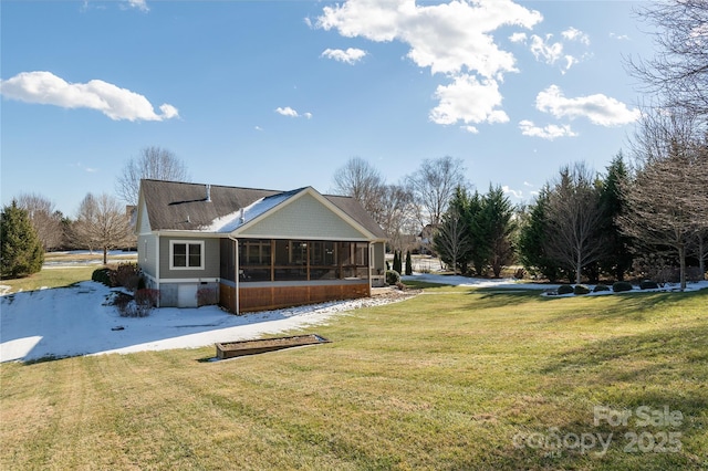 back of property with a yard and a sunroom