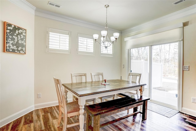 dining room featuring a chandelier, crown molding, and hardwood / wood-style floors