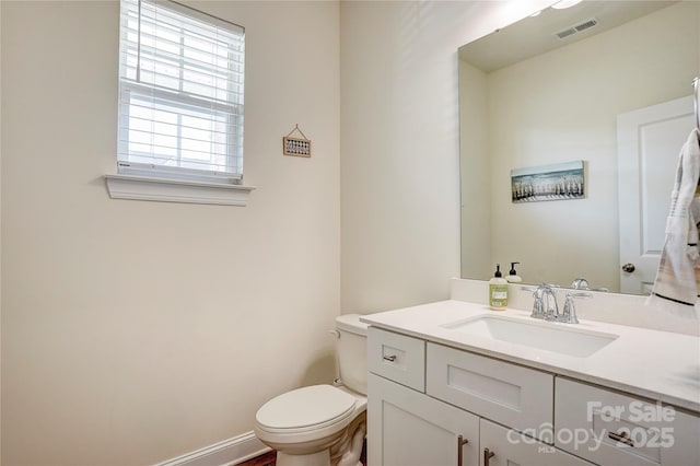 bathroom with toilet and vanity