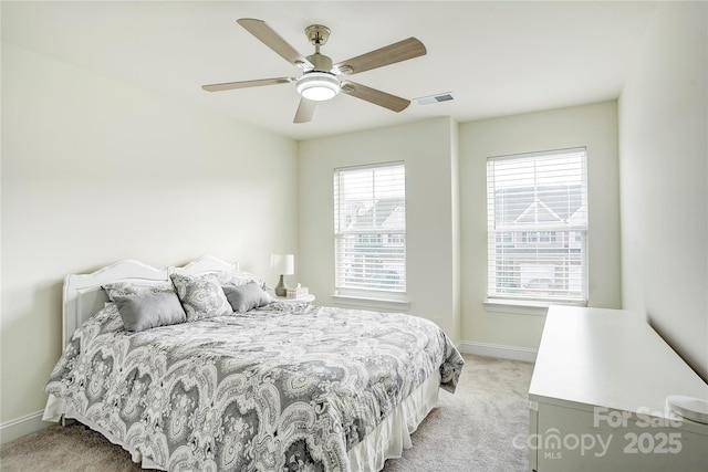 bedroom featuring ceiling fan and light colored carpet