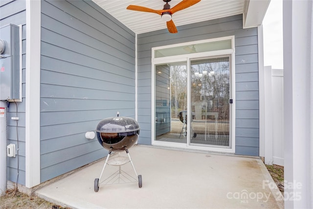 entrance to property featuring ceiling fan and a patio area