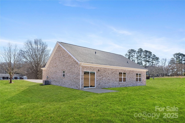 rear view of house featuring a yard, a patio, and central air condition unit