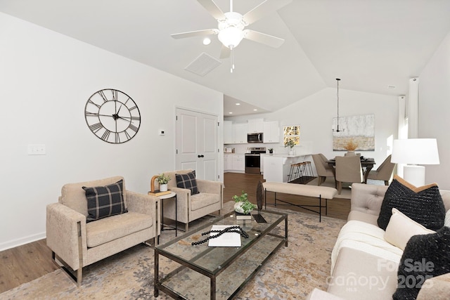 living room featuring lofted ceiling, ceiling fan, and light wood-type flooring