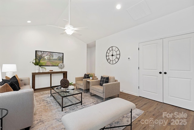 living room featuring ceiling fan, lofted ceiling, and light hardwood / wood-style floors