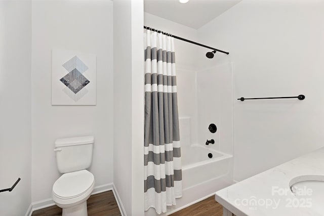 full bathroom with vanity, hardwood / wood-style floors, shower / tub combo, and toilet