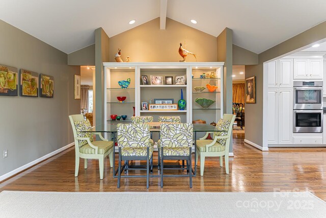 dining space with baseboards, lofted ceiling with beams, wood finished floors, and recessed lighting