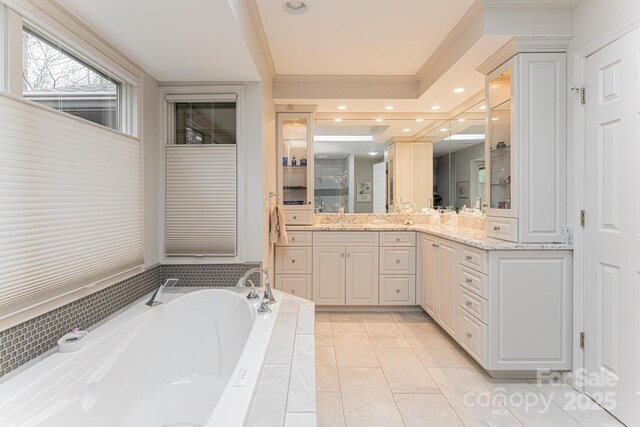 bathroom with a garden tub, walk in shower, vanity, ornamental molding, and recessed lighting