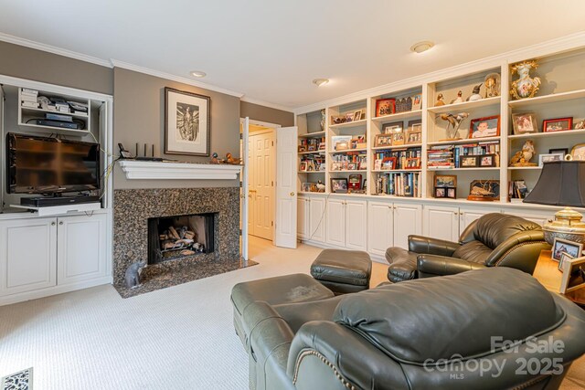living area with light colored carpet, ornamental molding, visible vents, and a premium fireplace