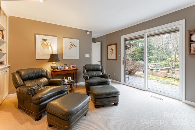 sitting room featuring visible vents, ornamental molding, baseboards, and light carpet