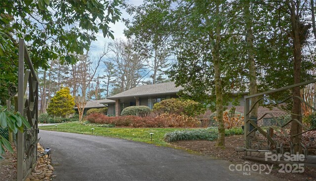 exterior space featuring roof with shingles