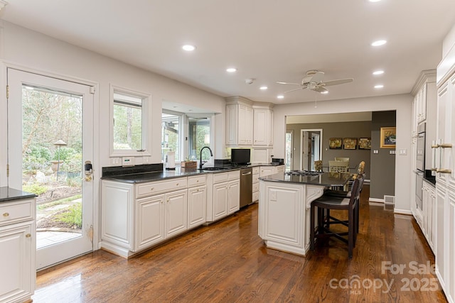 14 Stuyvesant Cres, Asheville, NC 28803 - kitchen featuring appliances with stainless steel finishes, a kitchen island, dark countertops, healthy amount of natural light, and recessed lighting