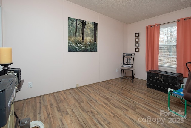 sitting room featuring hardwood / wood-style floors and a textured ceiling