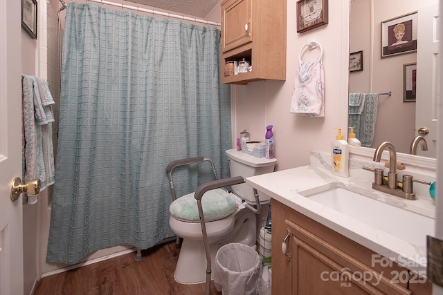 bathroom with wood-type flooring, vanity, toilet, a textured ceiling, and a shower with shower curtain