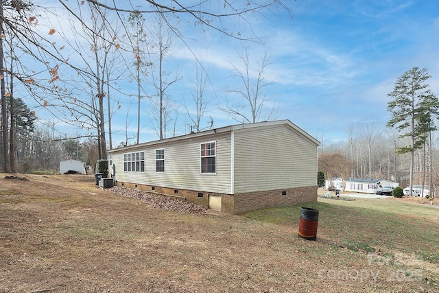 view of home's exterior featuring cooling unit and a lawn