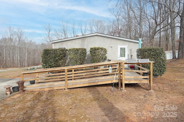 view of side of property featuring a wooden deck