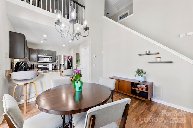 dining space featuring hardwood / wood-style flooring and an inviting chandelier