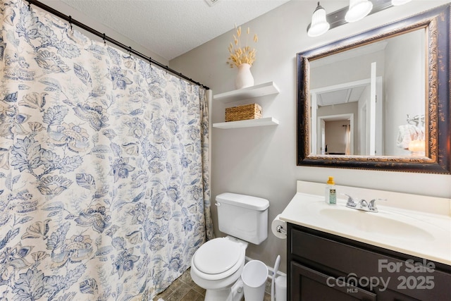 bathroom with toilet, a textured ceiling, walk in shower, and vanity