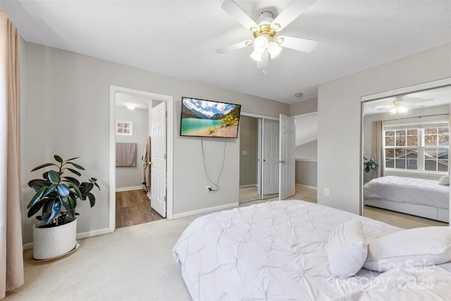 carpeted bedroom with ceiling fan, connected bathroom, and a textured ceiling