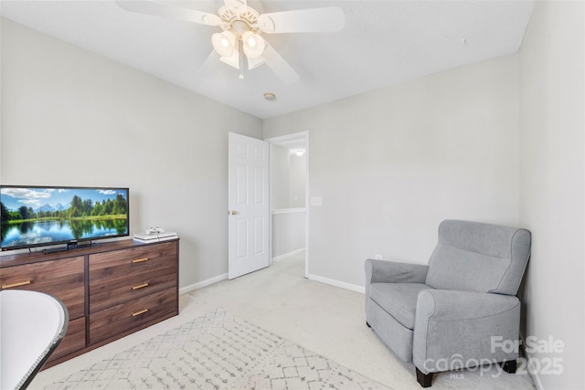 sitting room featuring ceiling fan and light carpet