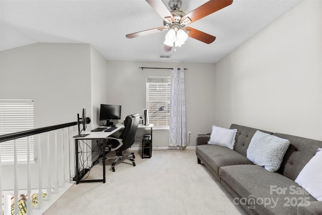 carpeted home office featuring ceiling fan, a textured ceiling, and lofted ceiling