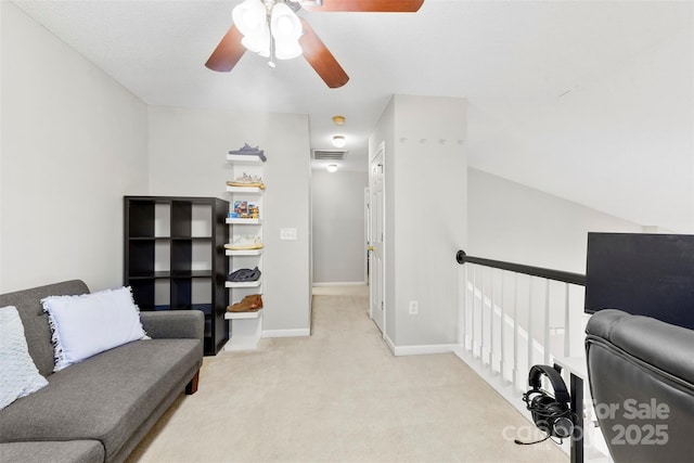 sitting room with ceiling fan and light carpet