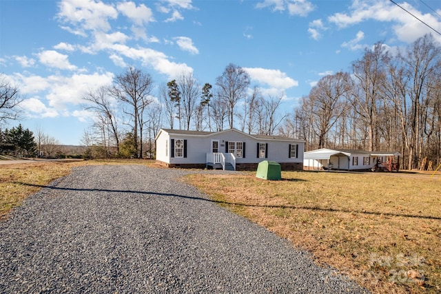 single story home featuring a front yard and a carport