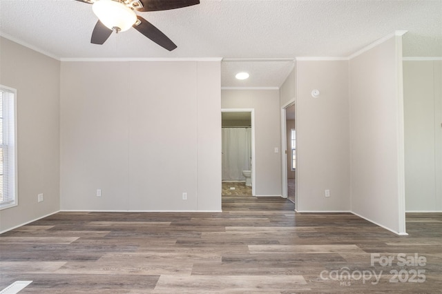 unfurnished room featuring hardwood / wood-style flooring, a textured ceiling, ceiling fan, and ornamental molding