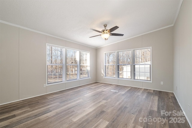 spare room with hardwood / wood-style floors, crown molding, a textured ceiling, ceiling fan, and lofted ceiling