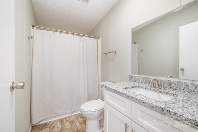 bathroom featuring vanity, toilet, and a textured ceiling