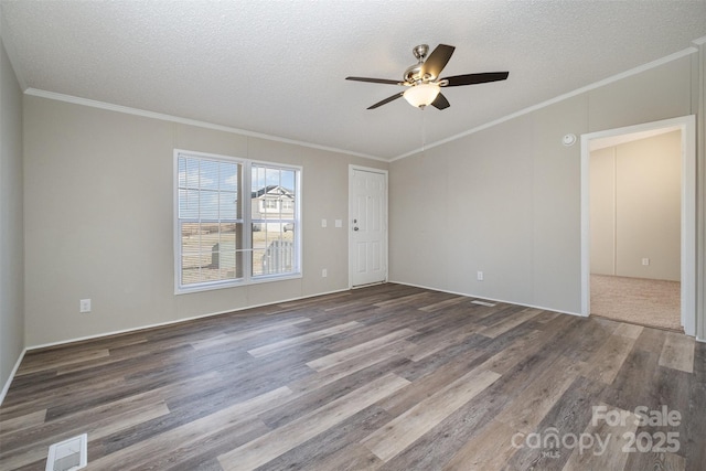 spare room with a textured ceiling, dark hardwood / wood-style flooring, and crown molding