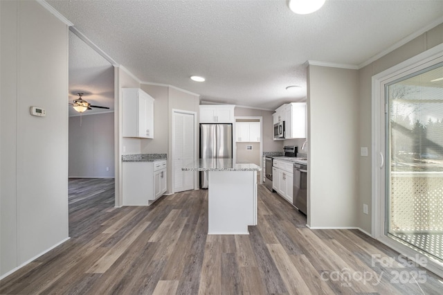 kitchen featuring white cabinets, a center island, and stainless steel appliances