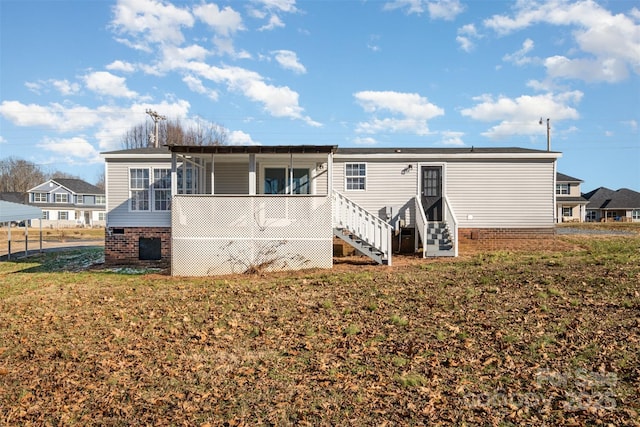 rear view of house with a yard