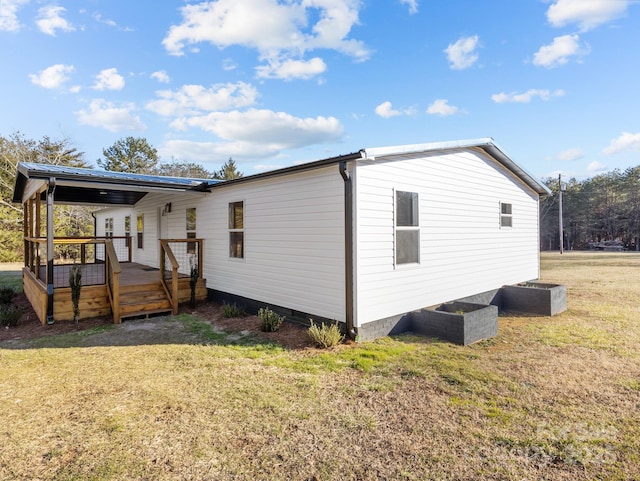 exterior space featuring a wooden deck and a lawn