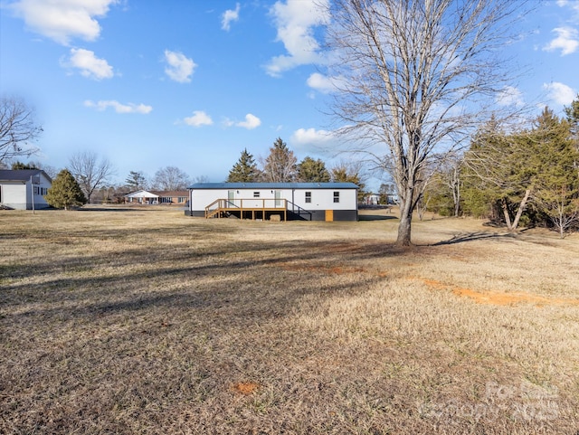 view of front of home featuring a front lawn and a deck