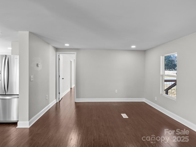 unfurnished room with dark hardwood / wood-style flooring