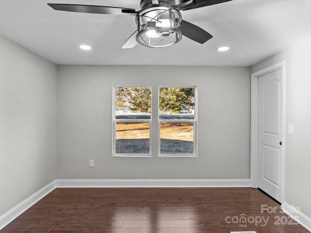 spare room with ceiling fan and dark hardwood / wood-style flooring