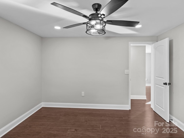 unfurnished room with ceiling fan and dark wood-type flooring