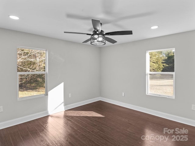 unfurnished room with ceiling fan and wood-type flooring