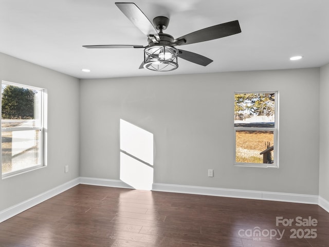 unfurnished room with ceiling fan and dark hardwood / wood-style floors